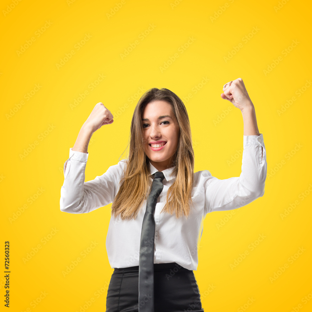 Young businesswoman winning on yellow background Young businesswoman winning on yellow background