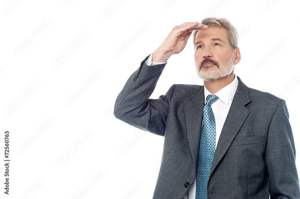 Senior businessman looking from far away Senior businessman looking from far away
