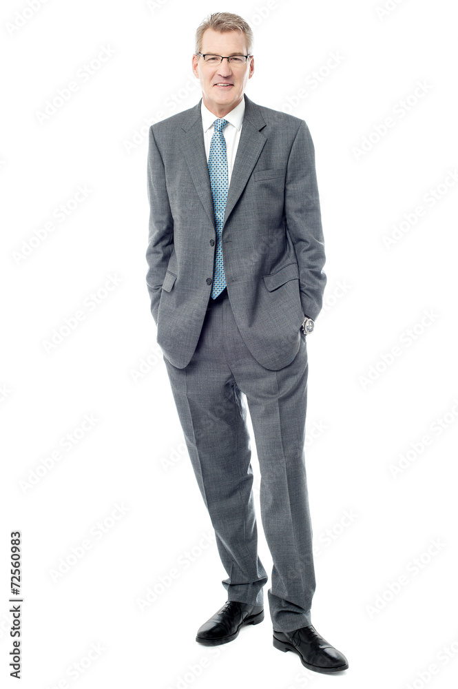 Confident businessman keeping his hands in pockets Confident businessman keeping his hands in pockets
