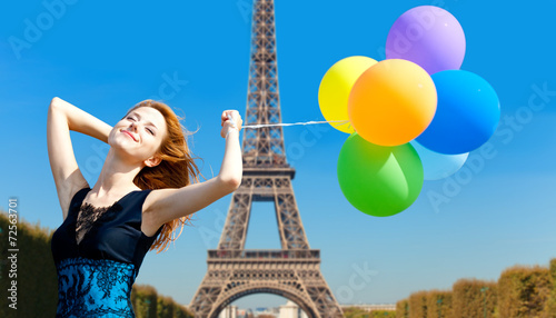 Redhead girl with colour balloons on parisian Eiffel tower backg © Masson