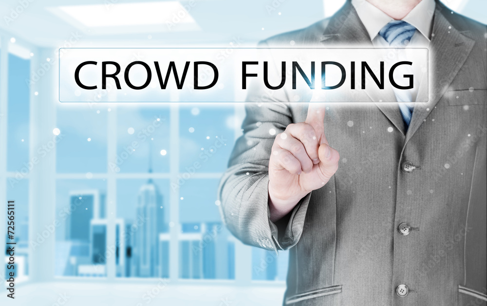Businessman pushes virtual crowd funding button Businessman pushes virtual crowd funding button