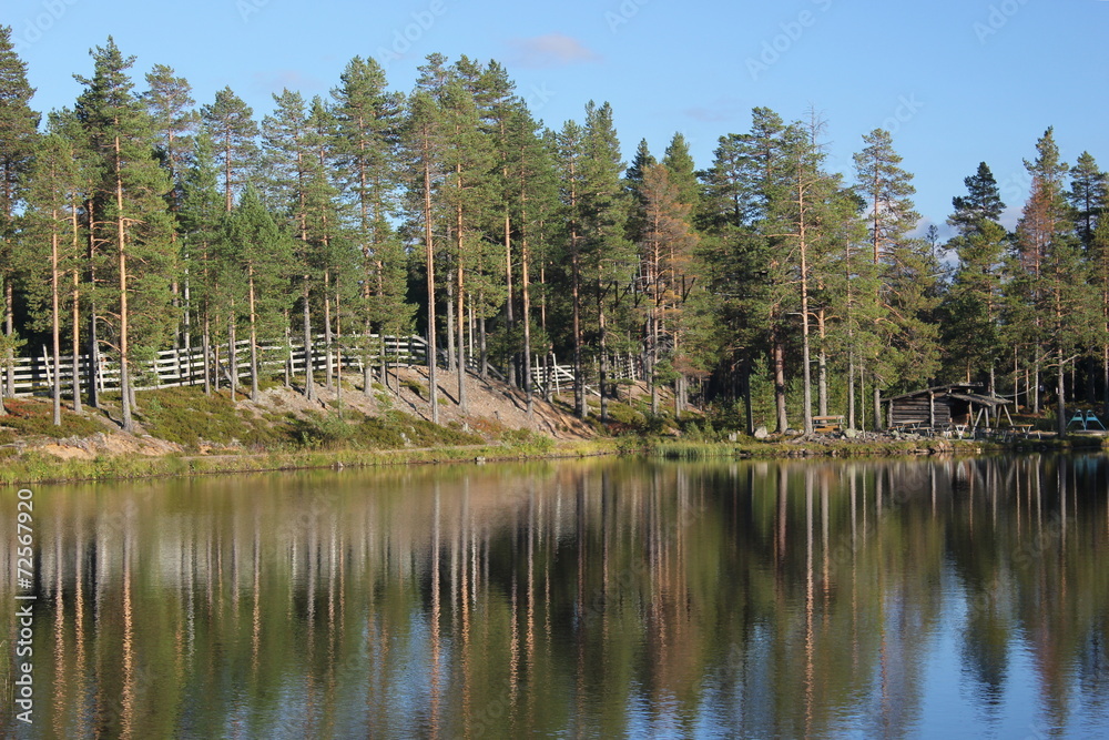 Swedish lake in Lindvallen near Salen, Dalarna, with a wooden platform on the water