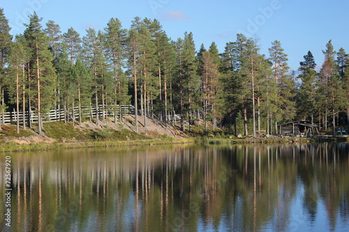 Swedish lake in Lindvallen near Salen, Dalarna, with a wooden platform on the water photo