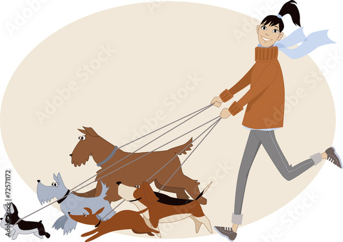 Young woman walking a bunch of dogs