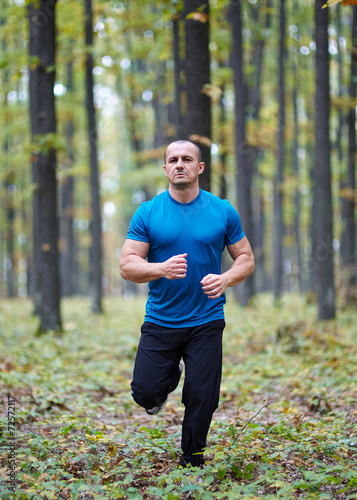 Fototapeta Naklejka Na Ścianę i Meble -  Man jogging in the forest
