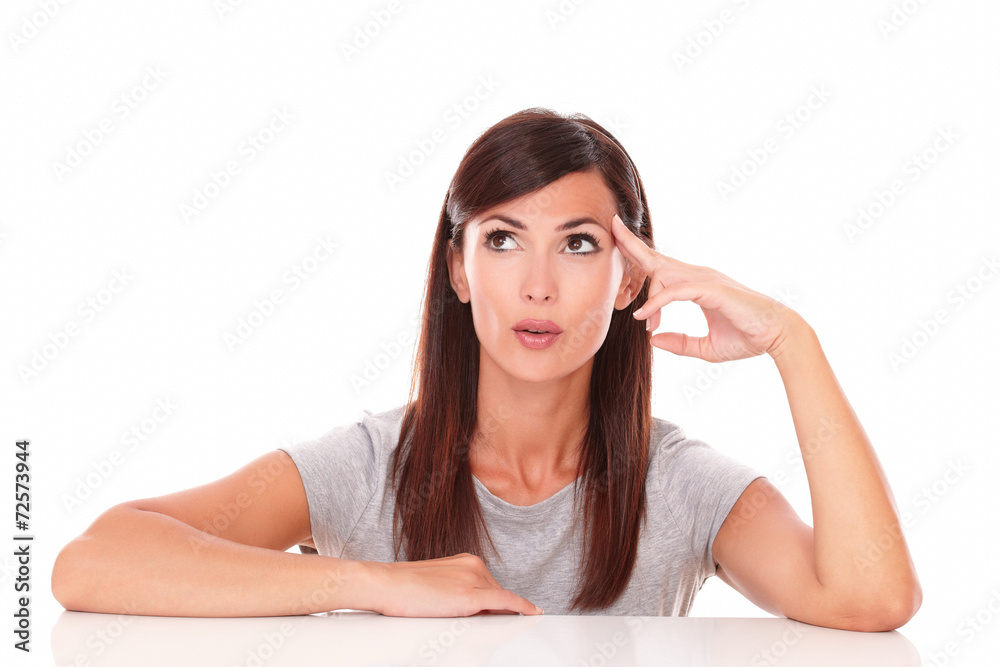 Reflective latin woman wondering while looking up Reflective latin woman wondering while looking up
