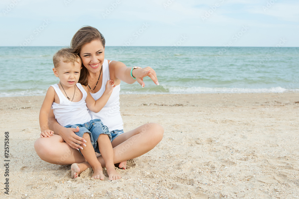 Mother and her son having fun on the beach