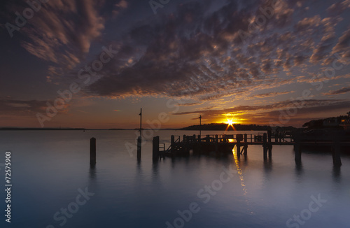 Sunset over a jetty near Brownsea Island in Poole Harbour photo