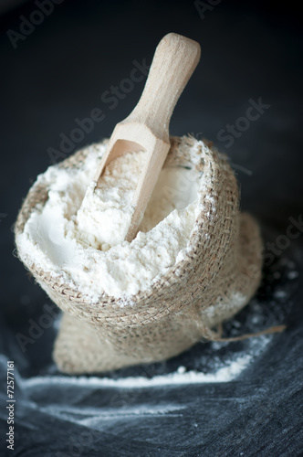 flour in burlap with wooden spoon