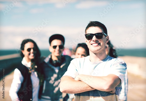 teenager in shades outside with friends