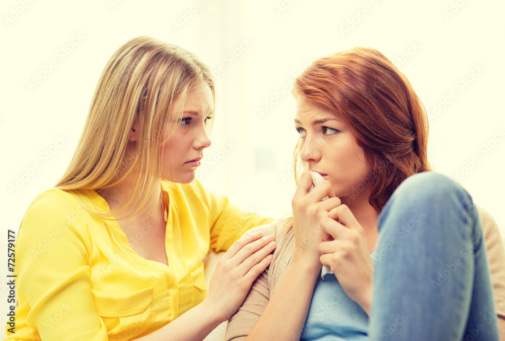 one teenage girl comforting another after break up one teenage girl comforting another after break up