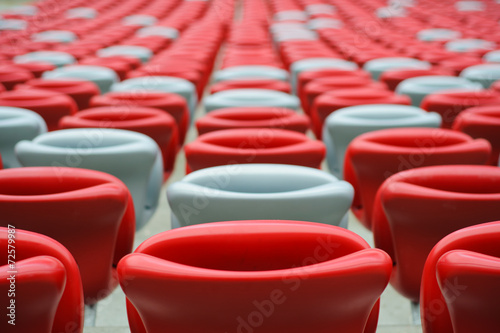 Several rows of red and white stadium seats