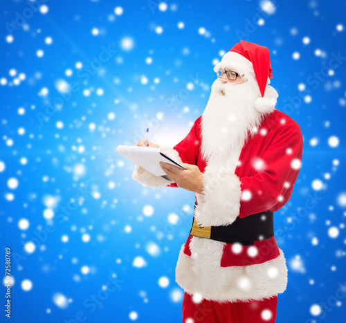 man in costume of santa claus with notepad © Syda Productions