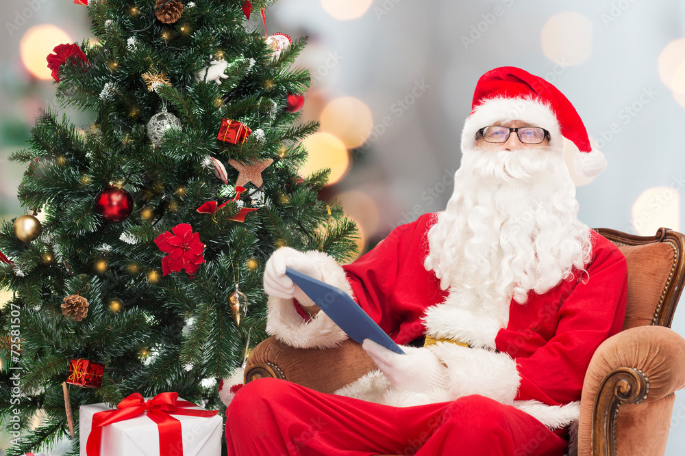 man in costume of santa claus with tablet pc man in costume of santa claus with tablet pc
