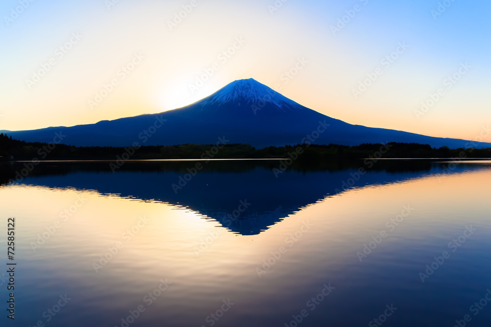 Sun shine and inverted Mount Fuji reflected in Lake Tanukiko