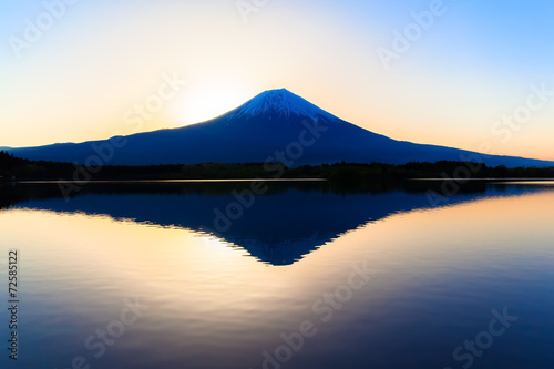 Sun shine and inverted Mount Fuji reflected in Lake Tanukiko