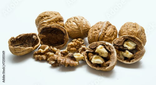 whole and cracked walnut isolated on the white background