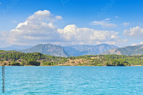View of the coast and the mountains from the water side.