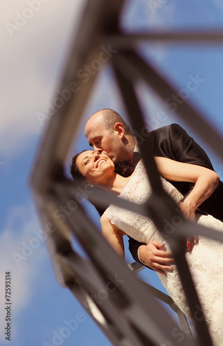 Romantic bride and groom on a bridge