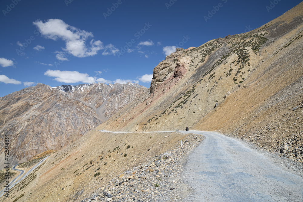 Lonely biker on mountain road