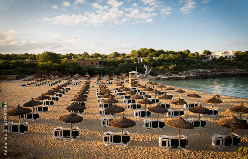 Fototapeta premium Beach umbrellas at sunset