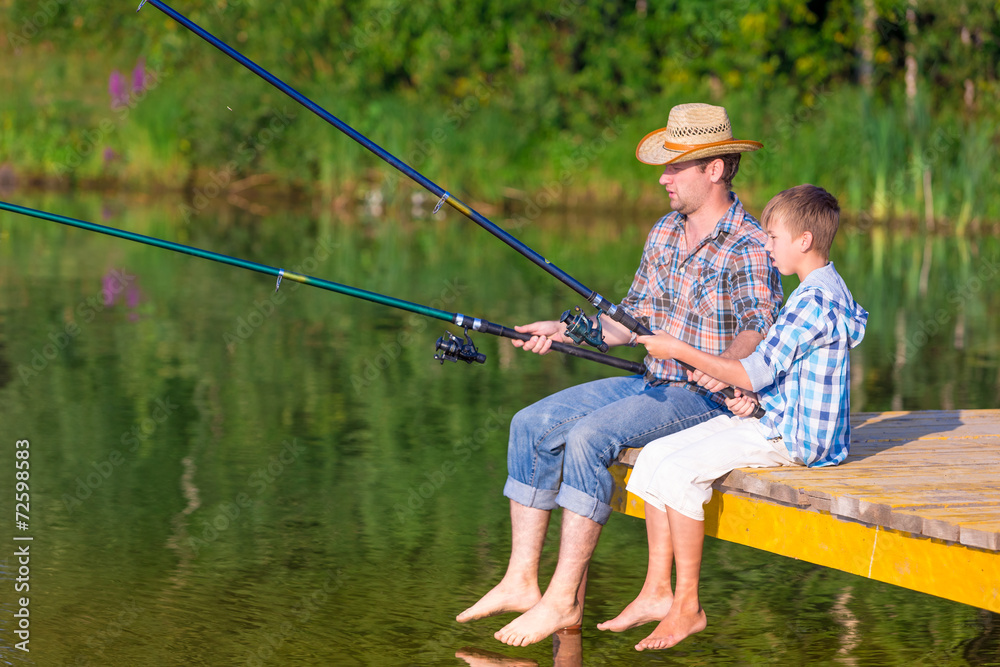 boy and his father fishing togethe boy and his father fishing togethe