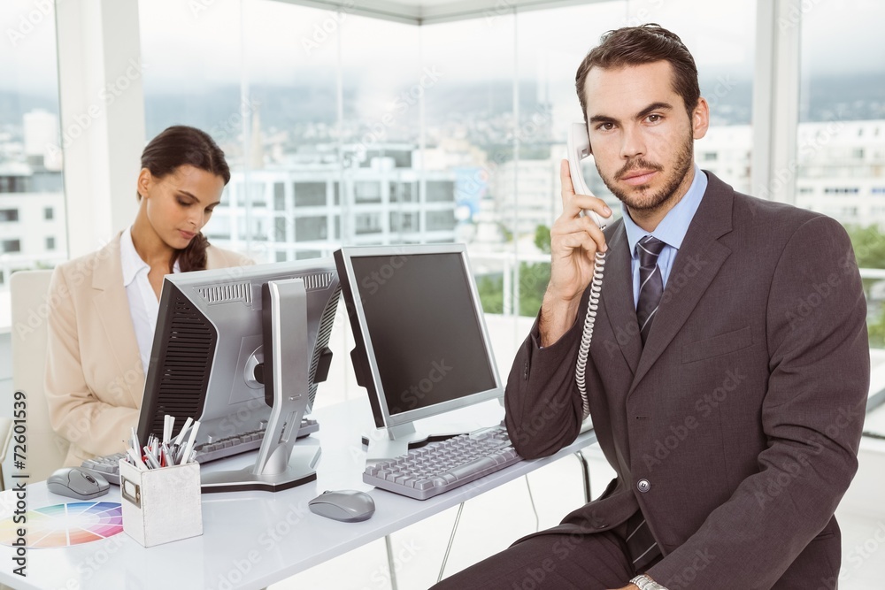 Business people using computers in office Business people using computers in office