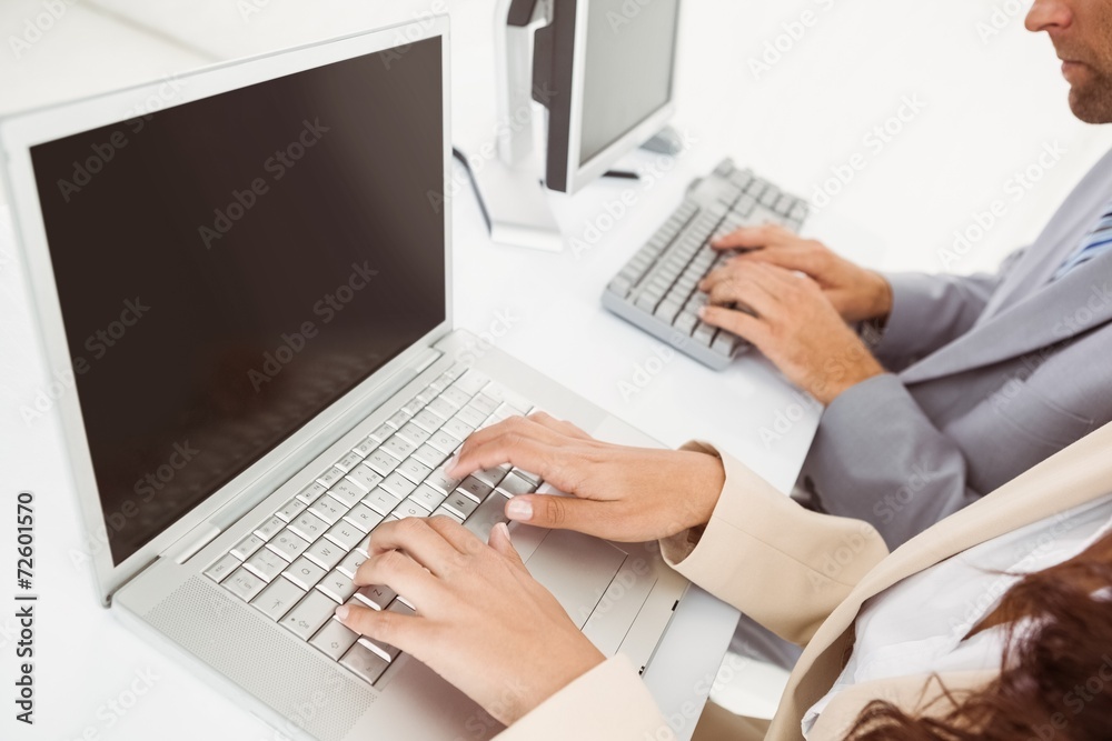 Hands using computers in office Hands using computers in office