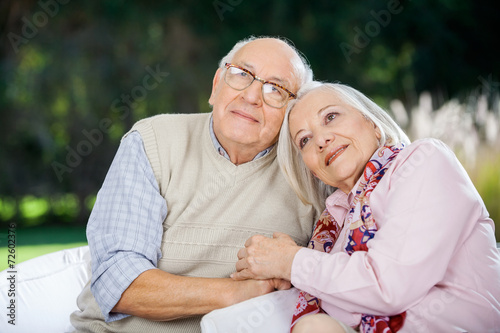 Loving Senior Couple Sitting On Chairs