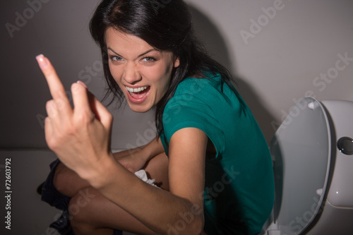 Bilde på lerret Portrait of young woman shouting in toilet to camera