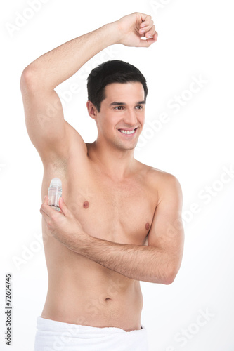 Young handsome men applying deodorant on armpits.