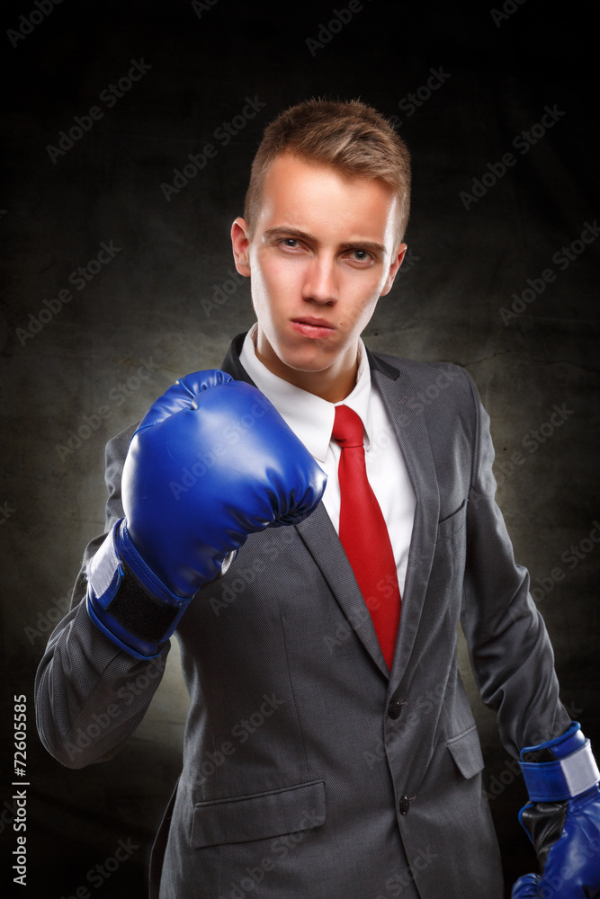 Businessman with boxing gloves showing his confidence.