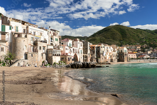 people at beach in Cefalu at spring time