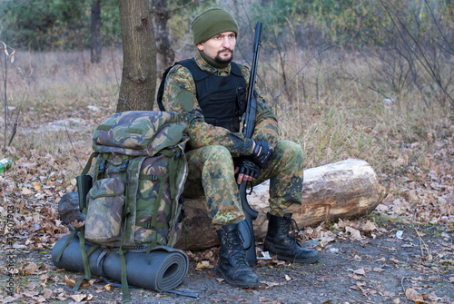 Soldier with a rifle in camouflage clothing