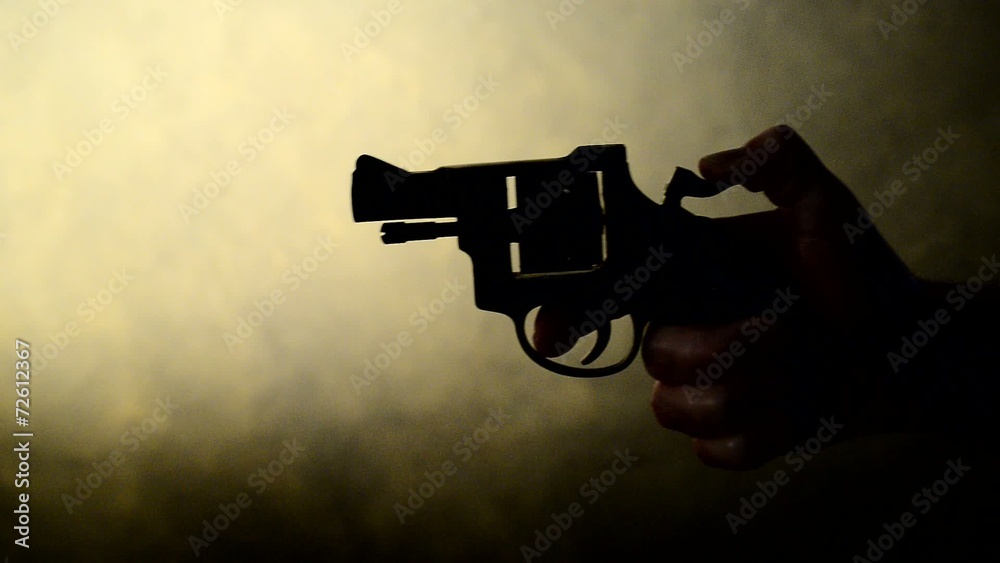 silhouette of a mans hand with a handgun,real time silhouette of a mans hand with a handgun,real time