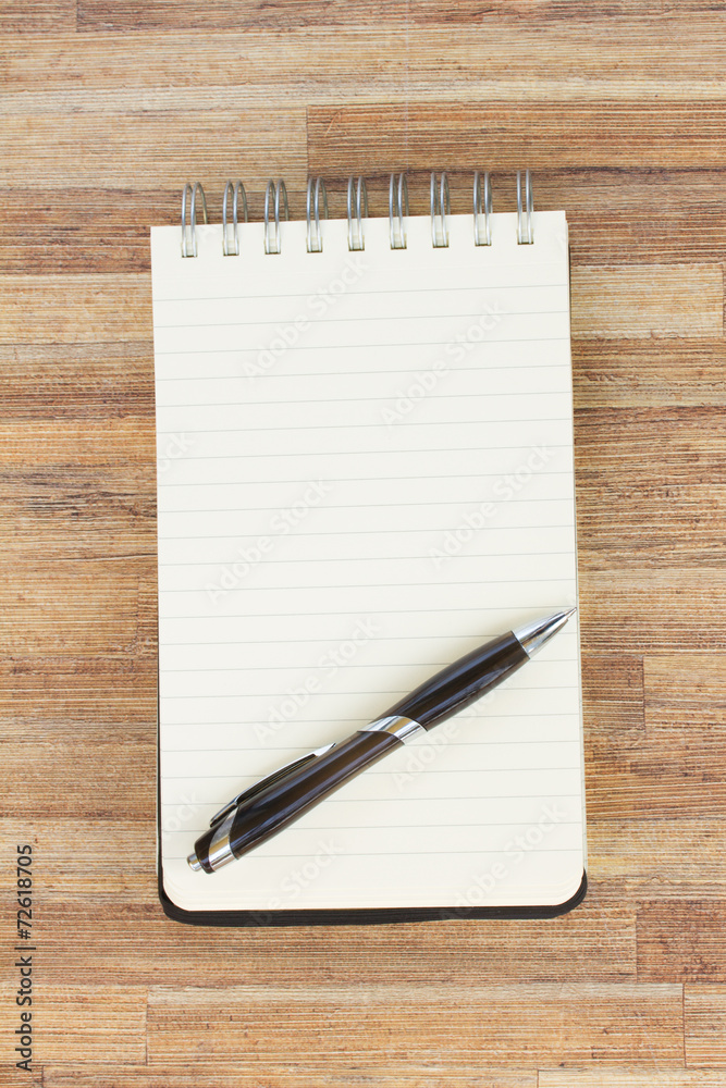 notebook on wooden table notebook on wooden table