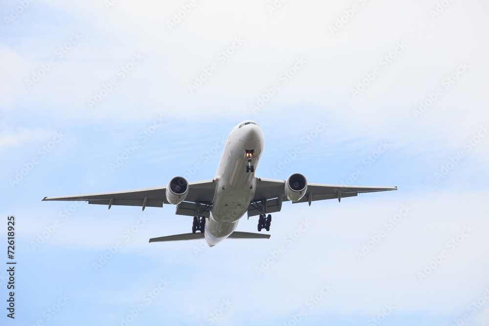passenger jet plane flying against beautiful blue sky with copy