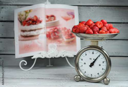 Kitchen Scale weighing strawberries and food magazine recipe