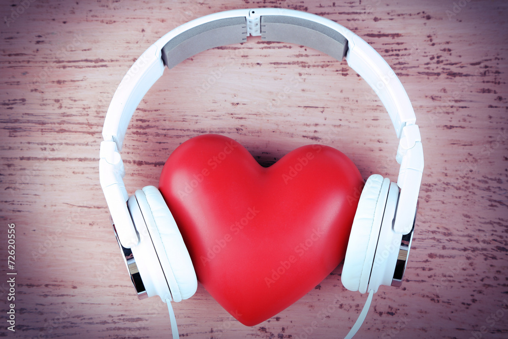 Headphones and heart on color wooden background - obrazy, fototapety, plakaty 
