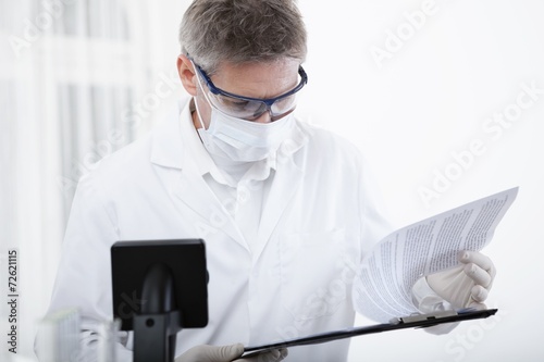 doctor working with clipboard and blood