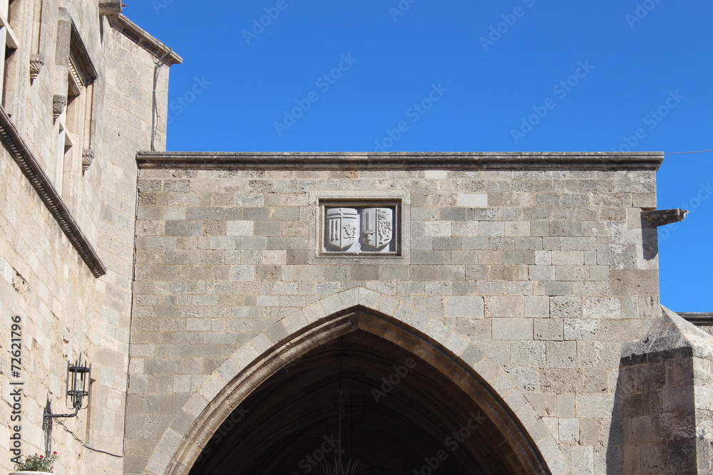 arms above the arched entrance