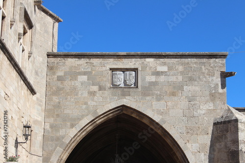 arms above the arched entrance