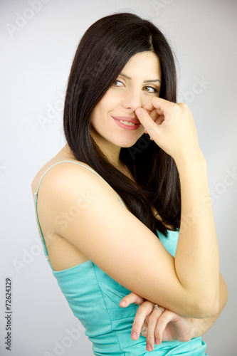 Gorgeous shy brunette woman smiling in studio