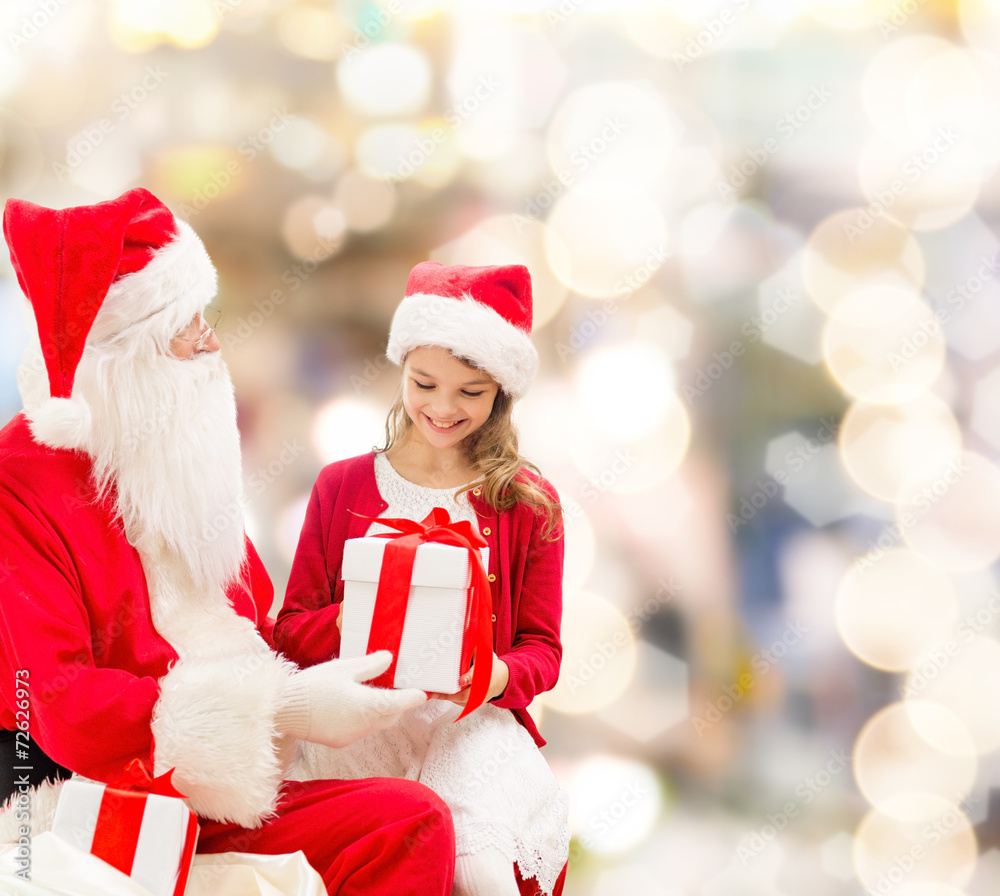 smiling little girl with santa claus and gifts smiling little girl with santa claus and gifts