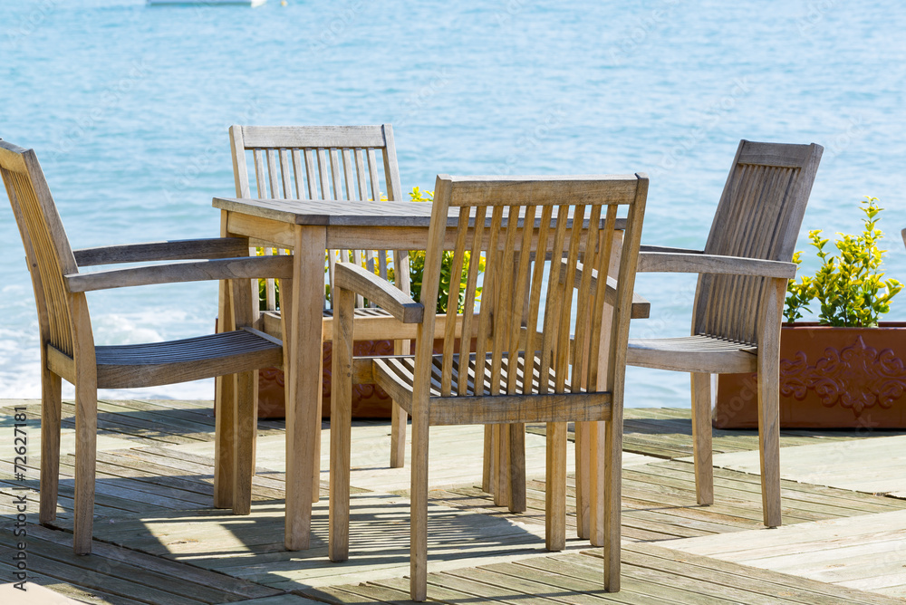 Cafe with wooden tables and chairs at  seaside