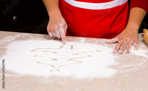 woman drawing into flour