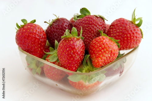 Red ripe strawberry in vessel at white background