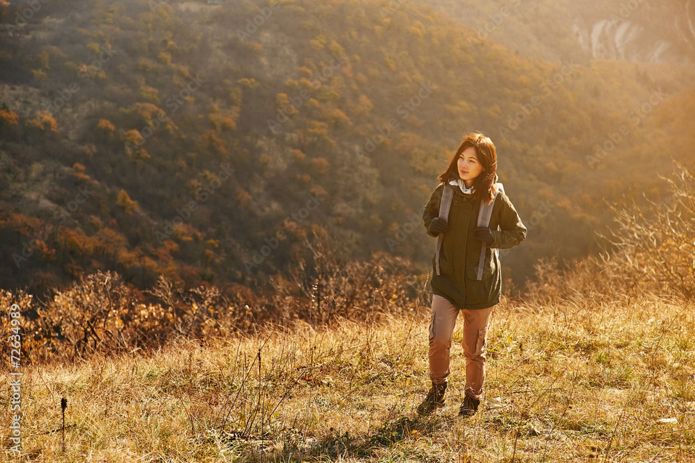 Hiker woman walking in the mountains