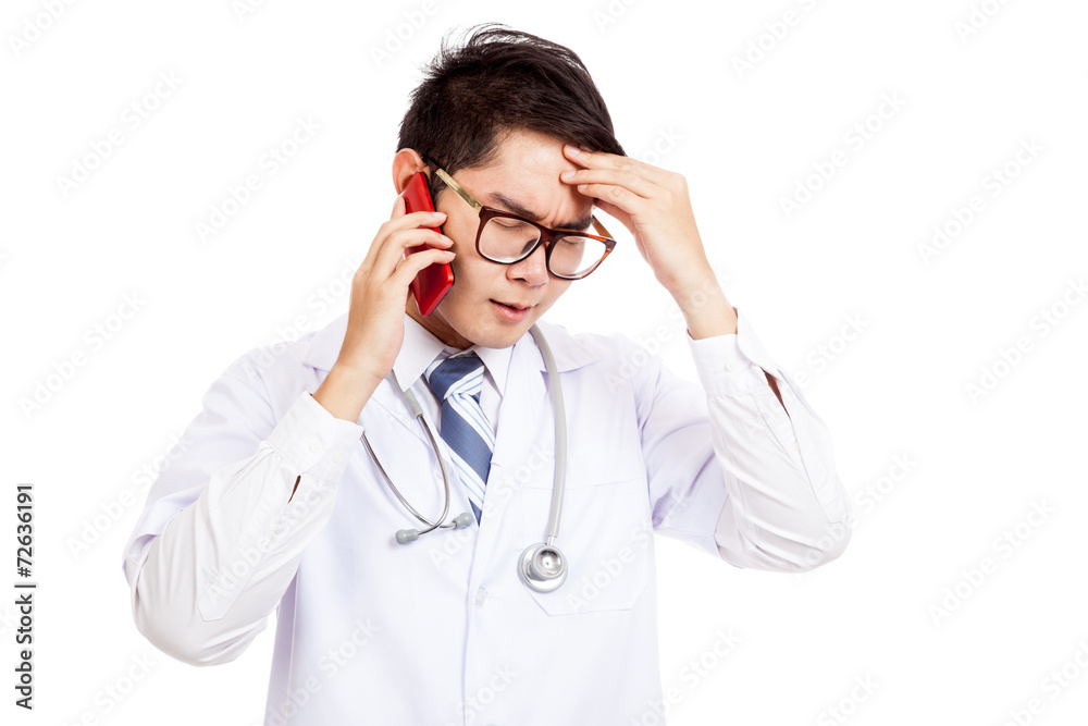 Asian male doctor got headache talk on mobile phone Asian male doctor got headache talk on mobile phone