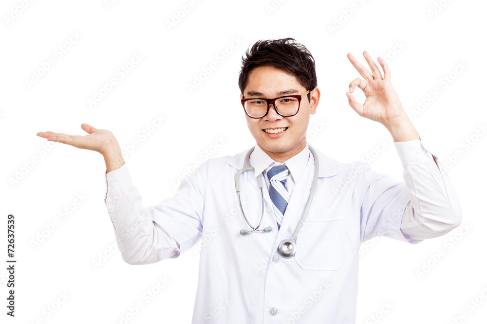Asian male doctor show palm hand and OK sign Asian male doctor show palm hand and OK sign